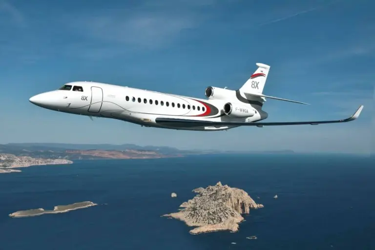 Falcon 8x flies above the water