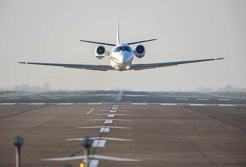 Private Jet in flight at airport