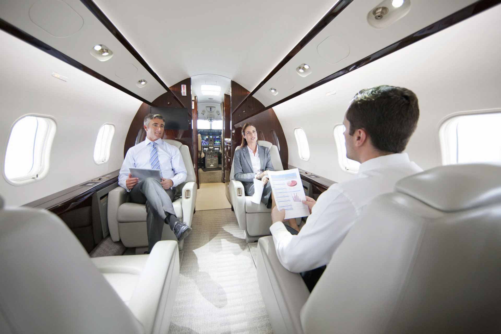 Travellers sitting inside a private jet