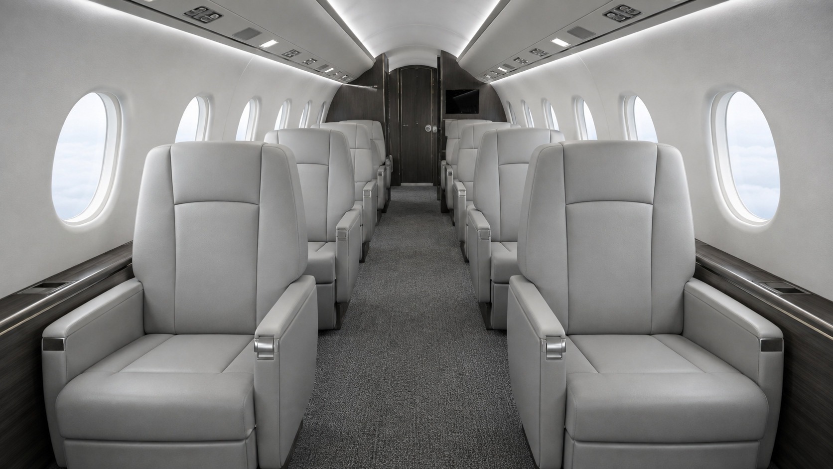 Empty business jet cabin photographed from the forward bulkhead looking aft