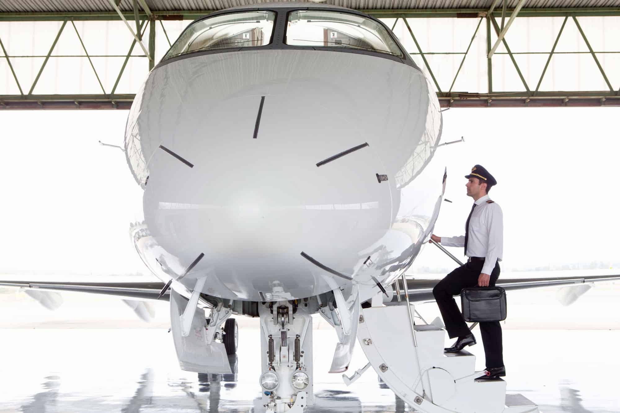 Pilot boarding private jet