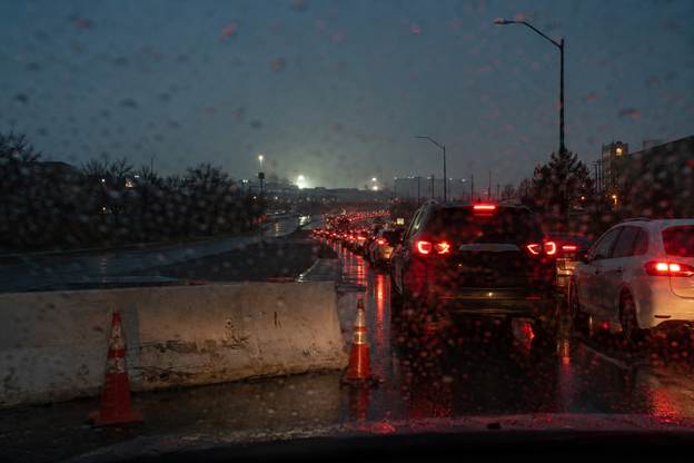 Stopped traffic on a closed approach road near a stadium on an event evening
